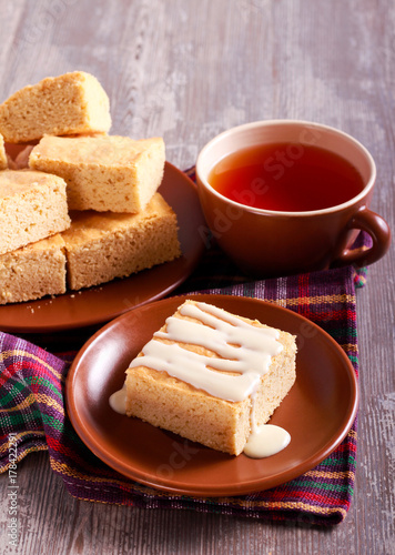 Blondies with glaze, served on plate