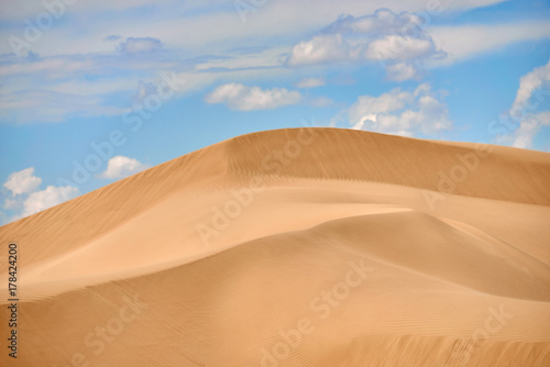 Sand dunes of Asia. In physical geography  a dune is a hill of loose sand built by wind or the flow of water.