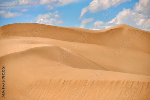 Sand dunes of Asia. In physical geography  a dune is a hill of loose sand built by wind or the flow of water.