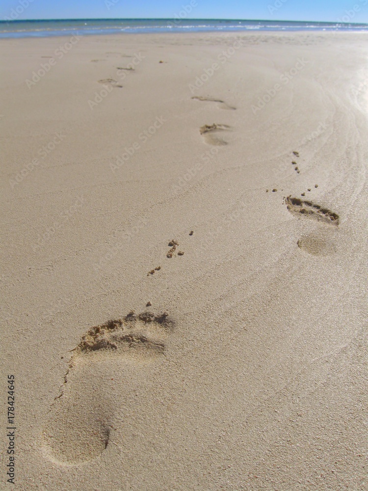 Footprints on wet sand at beach Footprints on wet sand at beach