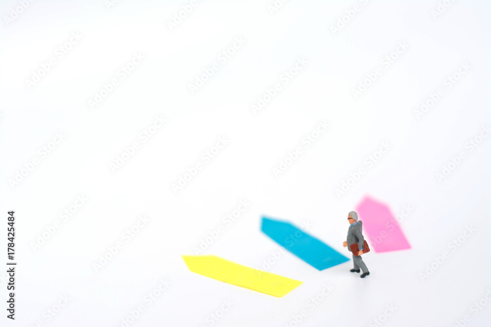 Three direction arrow choices, left, right or move forward, miniature model figure of businessman are taking decisions for the future, choice way. Three direction arrow choices, left, right or move forward, miniature model figure of businessman are taking decisions for the future, choice way.