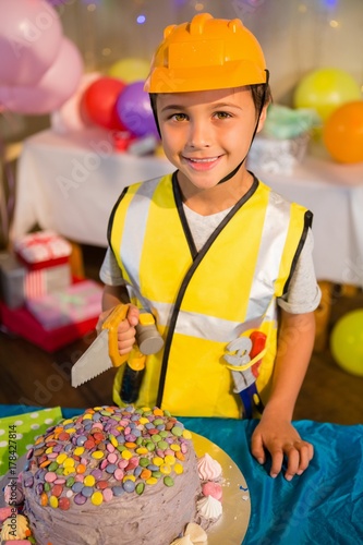 Boy pretending as a worker during birthday party photo