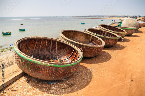 Idle basket boat on the beach in Tuy Phong, Binh Thuan, Vietnam. Tuy Phong district also has other beautiful landscapes, such as Ghenh Son, Nam Hai Tomb, and yellow sand dunes