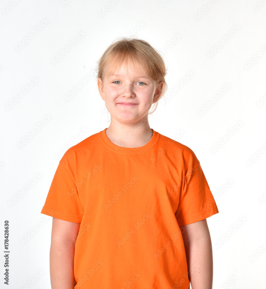 Girl on a white background. A girl in a T-shirt. A child smiles. Girl on a white background. A girl in a T-shirt. A child smiles.