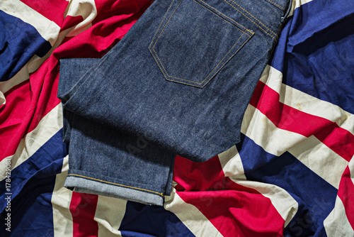 Blue Jeans Denim, 100% Cotton Unsanforized Denim Red Selvage Jeans on The Flag of England background, selective focus (detailed close-up shot) photo