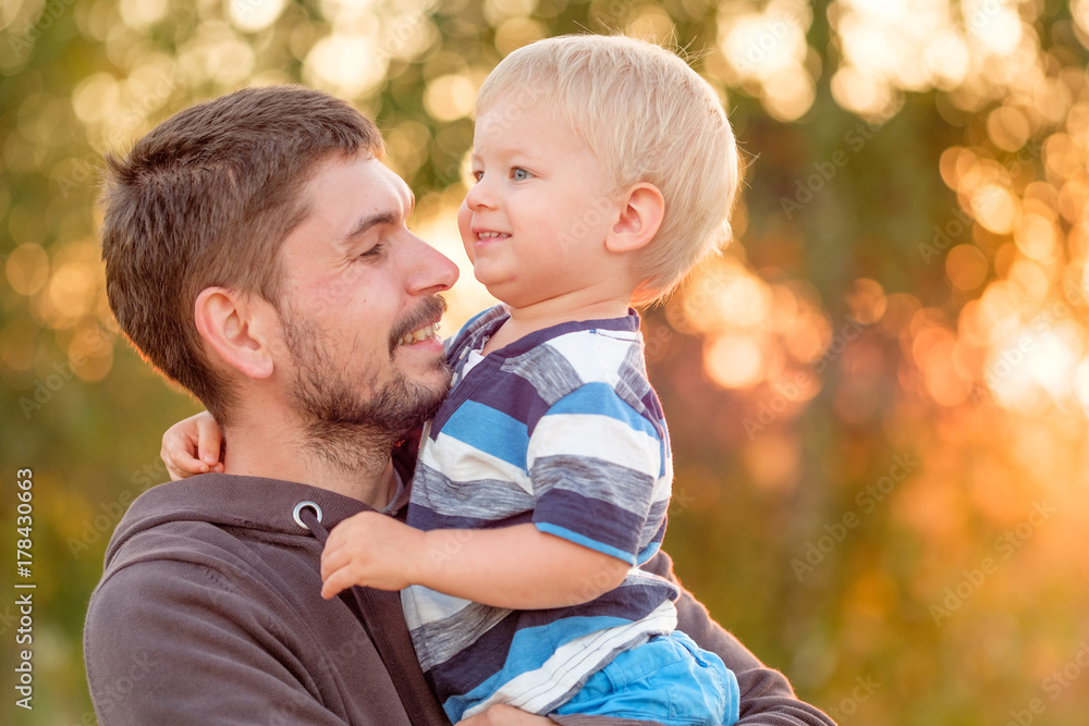 Father and son outdoor portrait in sunset sunlight Father and son outdoor portrait in sunset sunlight