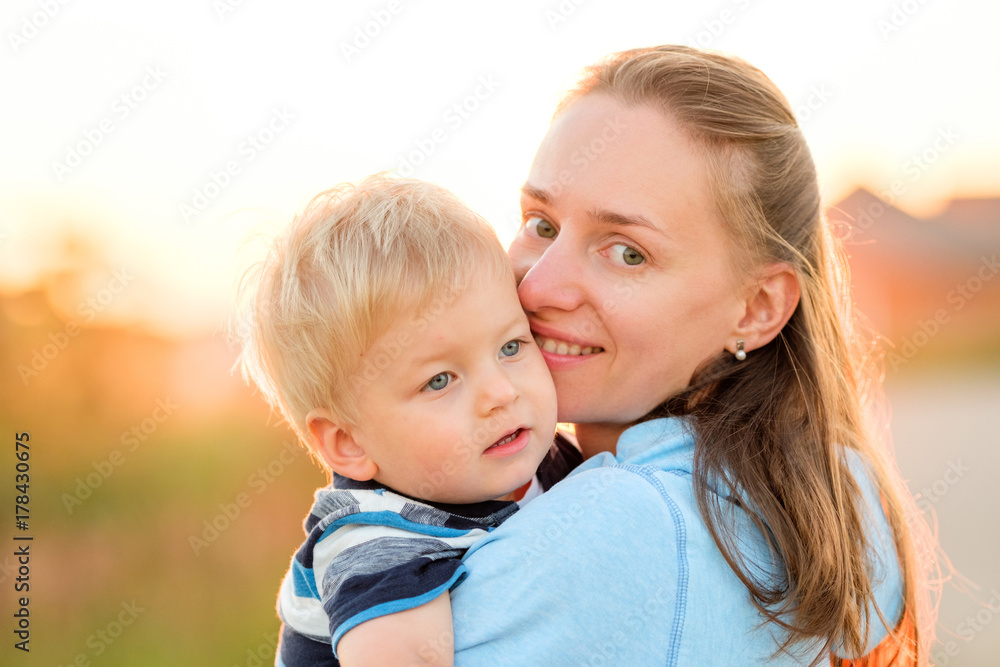 Woman and child having fun outdoors in sunset sunlight Woman and child having fun outdoors in sunset sunlight