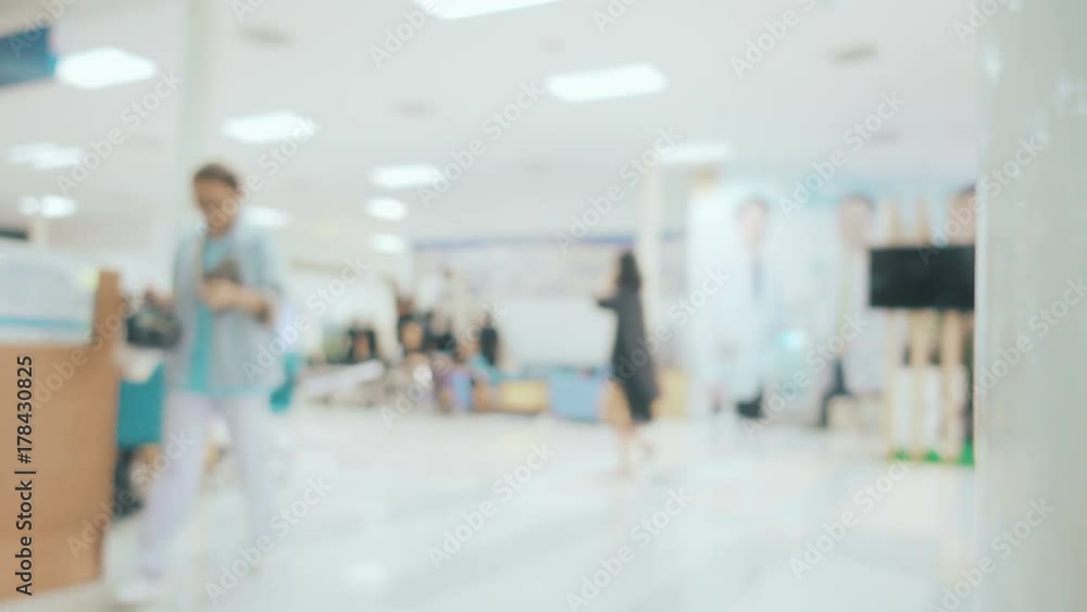 Blurred image with people walking and used wheelchair in hospital Blurred image with people walking and used wheelchair in hospital