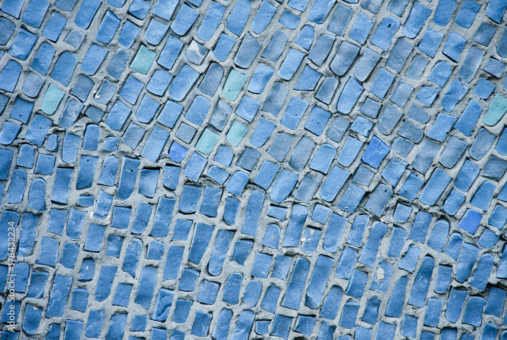 Fototapeta premium Background of blue ceramic mosaic. A wall with a textured surface.