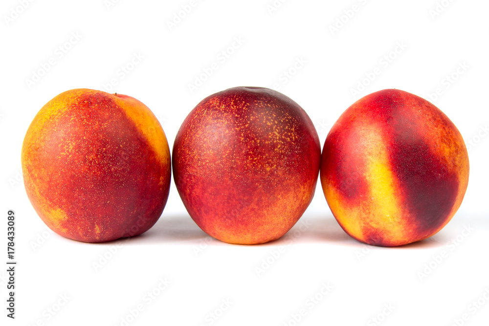 Juicy ripe peaches on the white background in macro Juicy ripe peaches on the white background in macro