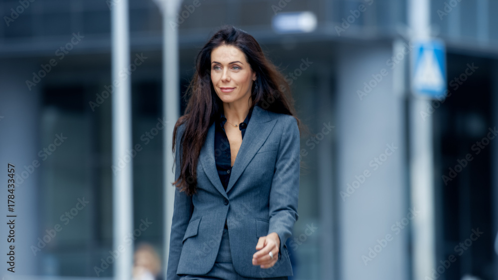 Business Woman in the Tailored Suit Walking on the Busy Big City Street in the Business District. Confident Woman on Her Way to do Big Business. Business Woman in the Tailored Suit Walking on the Busy Big City Street in the Business District. Confident Woman on Her Way to do Big Business.