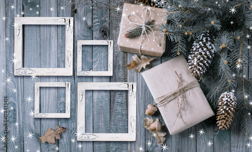 Christmas background with gift box and frames on wooden planks