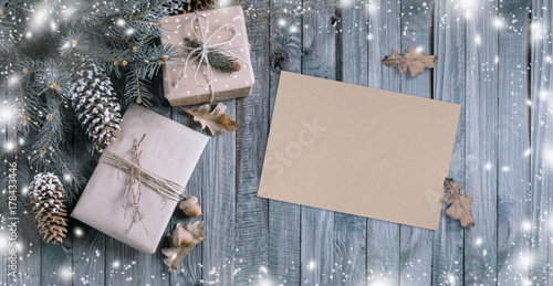 Christmas background with gift box and kraft eco paper in vintage style on wooden planks