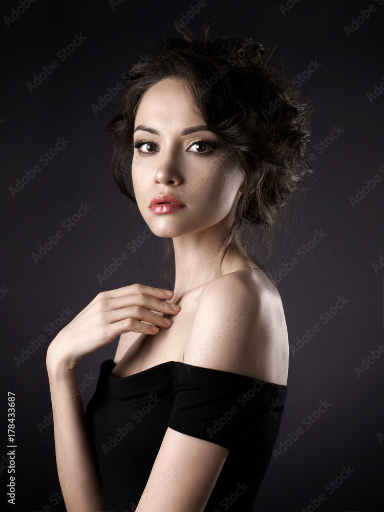 Fototapeta premium Beautiful woman with elegant hairstyle on black background