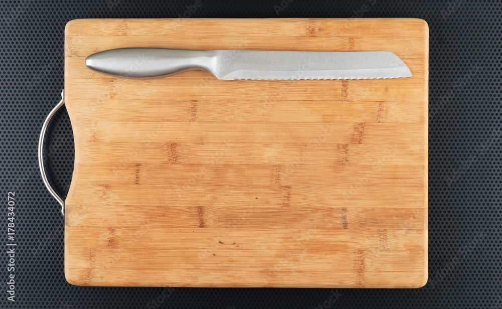 Kitchen cutting board and knife on a table