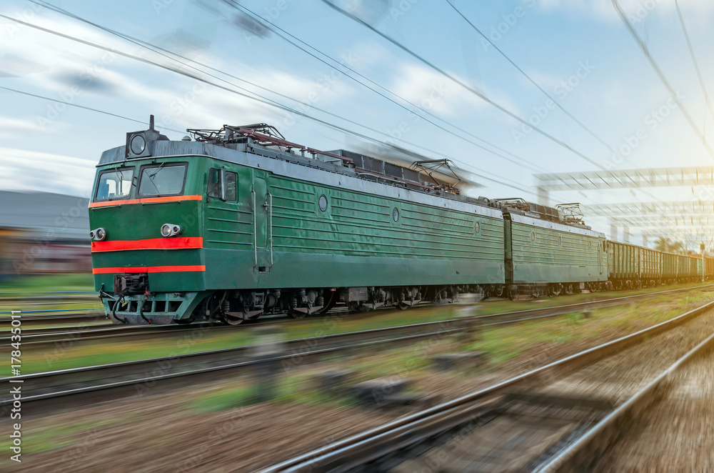 Locomotive electric with a freight train at high speed rides by rail. Locomotive electric with a freight train at high speed rides by rail.