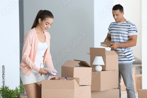 Young couple unpacking boxe...
