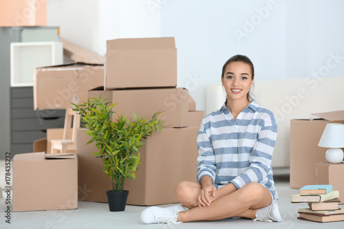Happy young woman sitting o...
