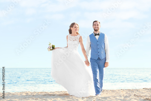 Happy wedding couple on sea...