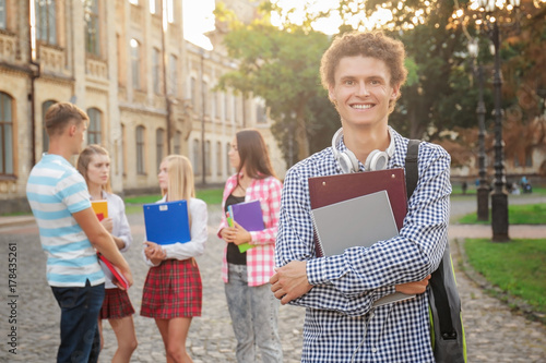 Young male student with fri...