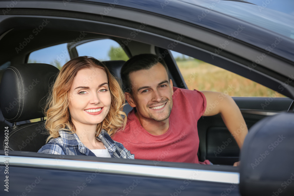 Beautiful young couple in car