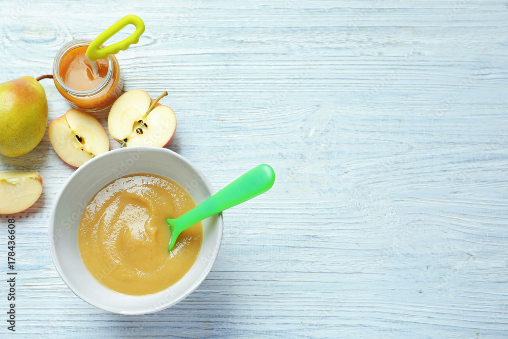 Composition with baby food on wooden background Composition with baby food on wooden background