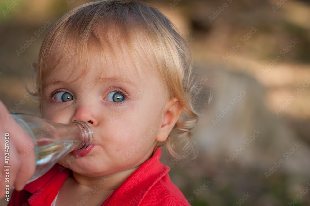 Kleines Mädchen trinkt Wasser aus Flasche Kleines Mädchen trinkt Wasser aus Flasche