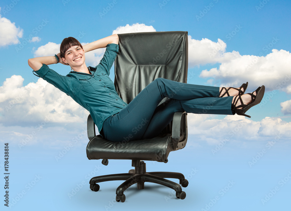 Happy business woman get rest on director's chair. Concept of success