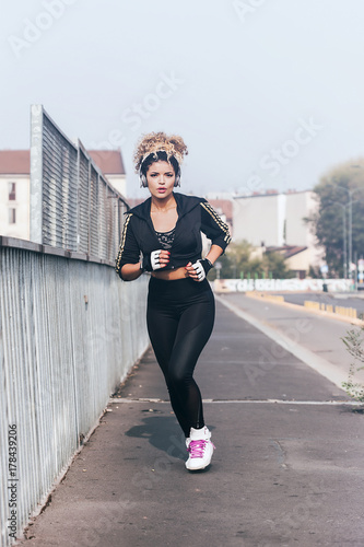 Beautiful jogger portrait running in the city