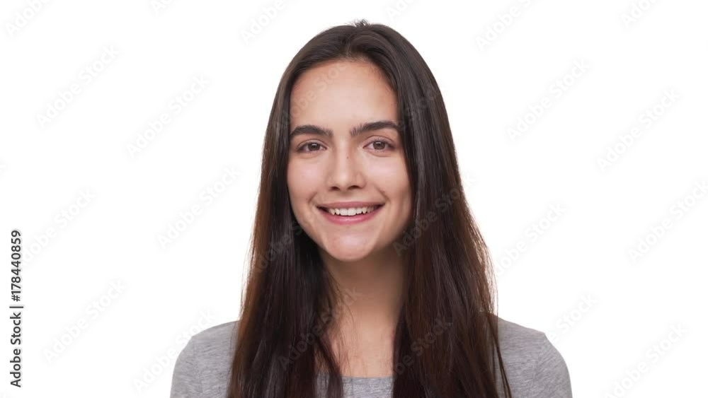 portrait of charming happy female model with long dark hair looking at camera smiling isolated over white background closeup. Concept of emotions portrait of charming happy female model with long dark hair looking at camera smiling isolated over white background closeup. Concept of emotions