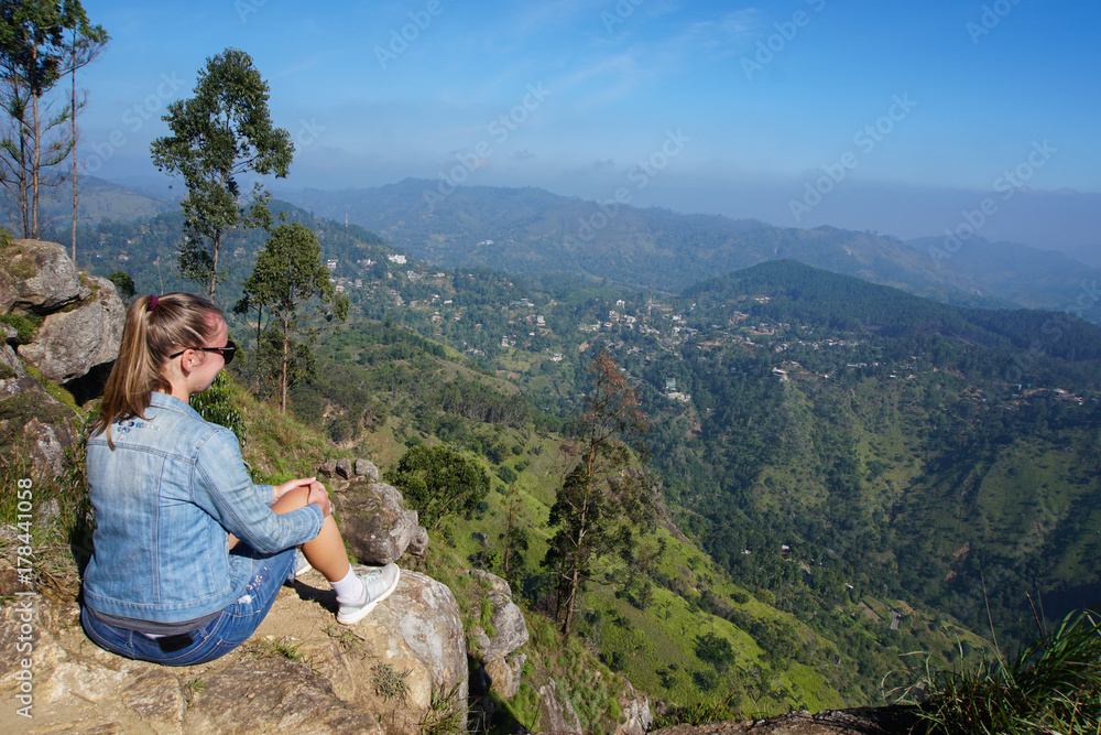 Female Tourist at Ella Peak Mountain in Sri Lanka Female Tourist at Ella Peak Mountain in Sri Lanka