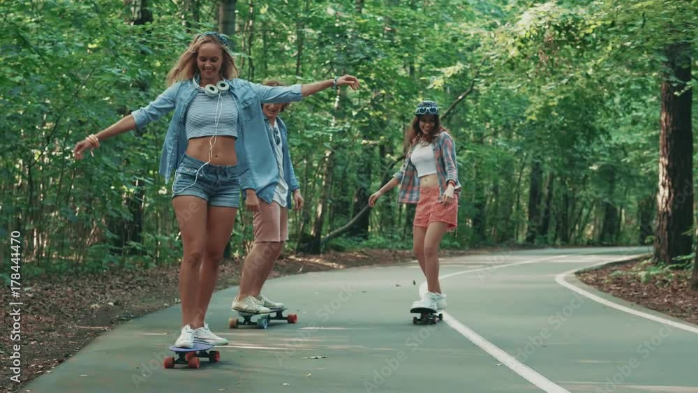 Happy youth on skateboards in the park Happy youth on skateboards in the park