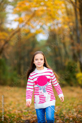 Fototapeta Naklejka Na Ścianę i Meble -  happy girl playing outdoors, running and having fun