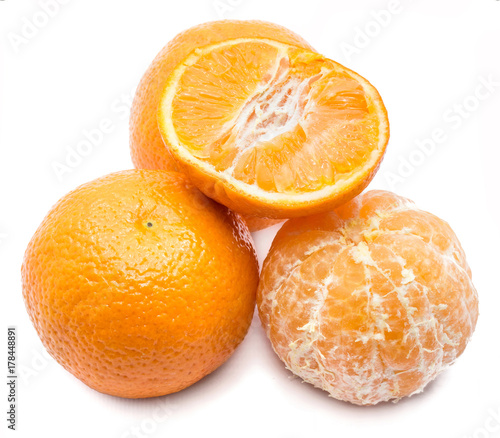 Clementines, one half, two whole and one peeled, isolated on white background