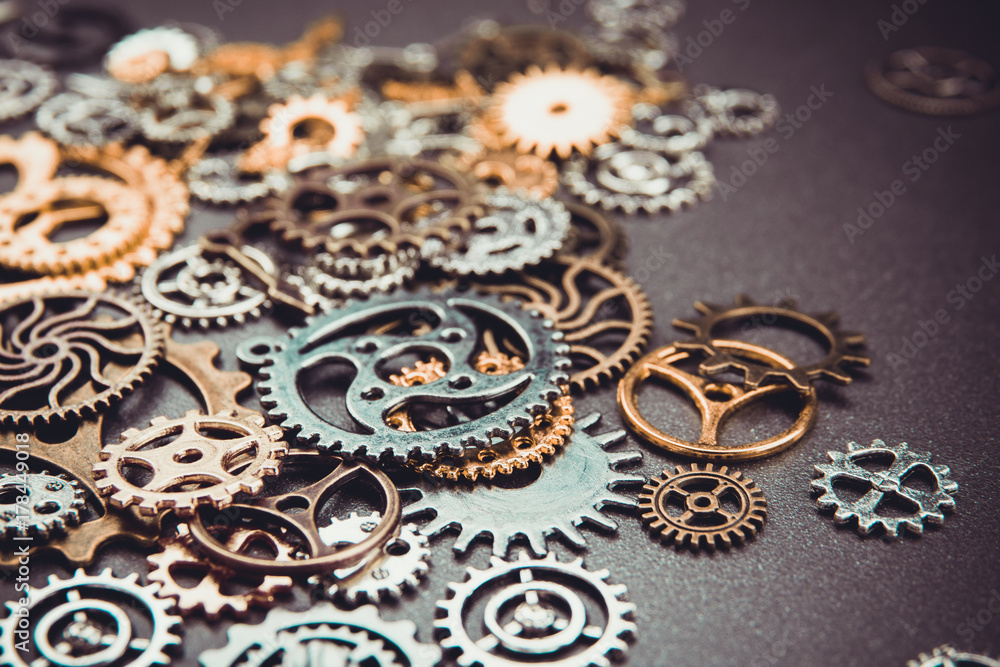 Assorted metal gears on gray background