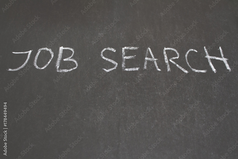 Fototapeta premium JOB search message hand written on the blackboard with white chalk. Copy space for text . Banner for job search.