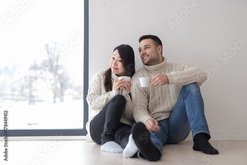 multiethnic couple enjoying morning coffee by the window © .shock