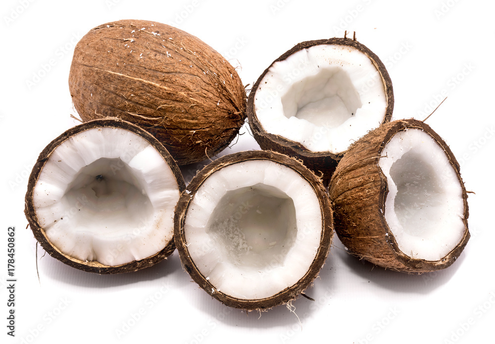 One whole coconut and four halves isolated on white background One whole coconut and four halves isolated on white background