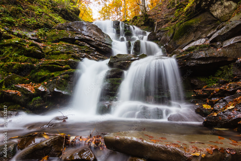 Autumn waterfall in forest landscape Autumn waterfall in forest landscape