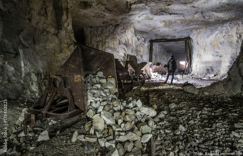 Miner at old wooden timbering in an abandoned limestone mine in Sock, Samara Region Miner at old wooden timbering in an abandoned limestone mine in Sock, Samara Region