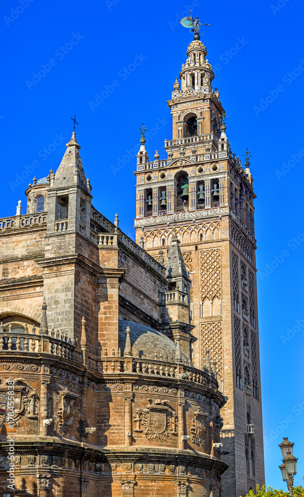 Beautiful Gothic building of the Cathedral of Saint Mary of the See (Seville Cathedral) on sunny day. Seville (Sevilla), Andalusia, Southern Spain.
