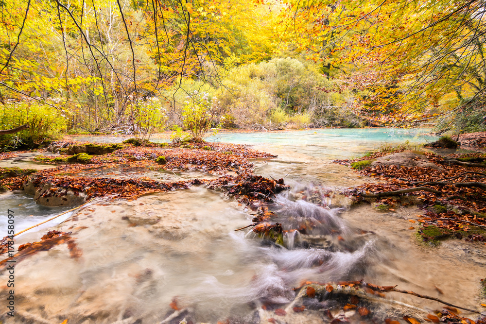 colorful autumn landscape at urederra source, Spain