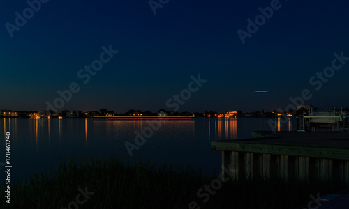 Dock  boat and marshes at sunset and blue hour off New Jersey inlet.