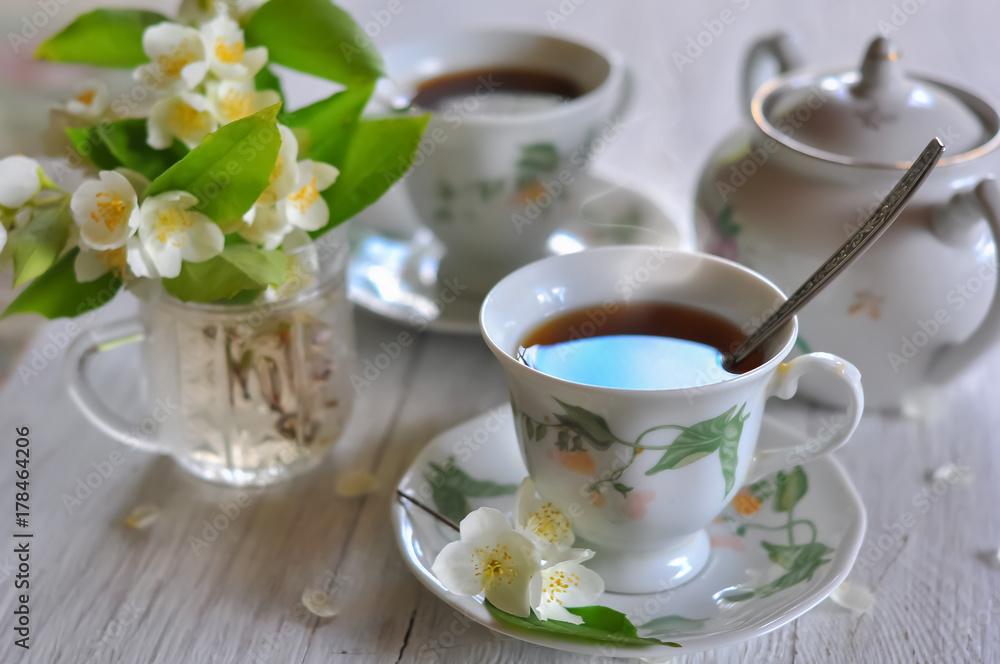 Tea drinking. Cups with tea and a vase with a jasmine. Tea drinking. Cups with tea and a vase with a jasmine.