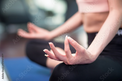 Young Asian woman practicing yoga pose at yoga healthy sport gym, yoga and meditation have good benefits for health. Photo concept for Yoga Sport and Healthy lifestyle