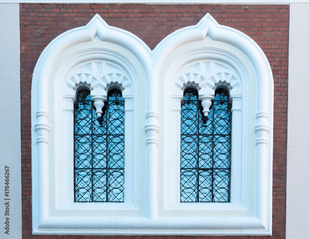 An old window. The facade of an house in colors. Background. Summer. Sunny day. An old window. The facade of an house in colors. Background. Summer. Sunny day.