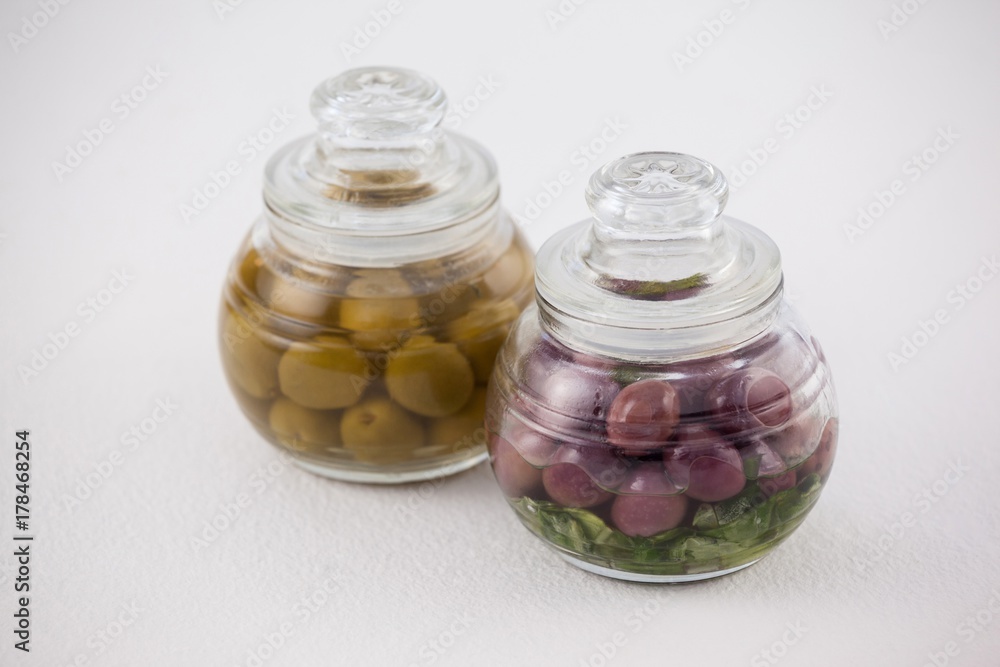 High angle view red and green olives in glass jar High angle view red and green olives in glass jar