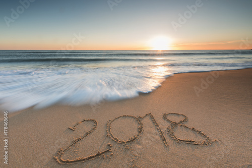2018 message written in the sand on the beach