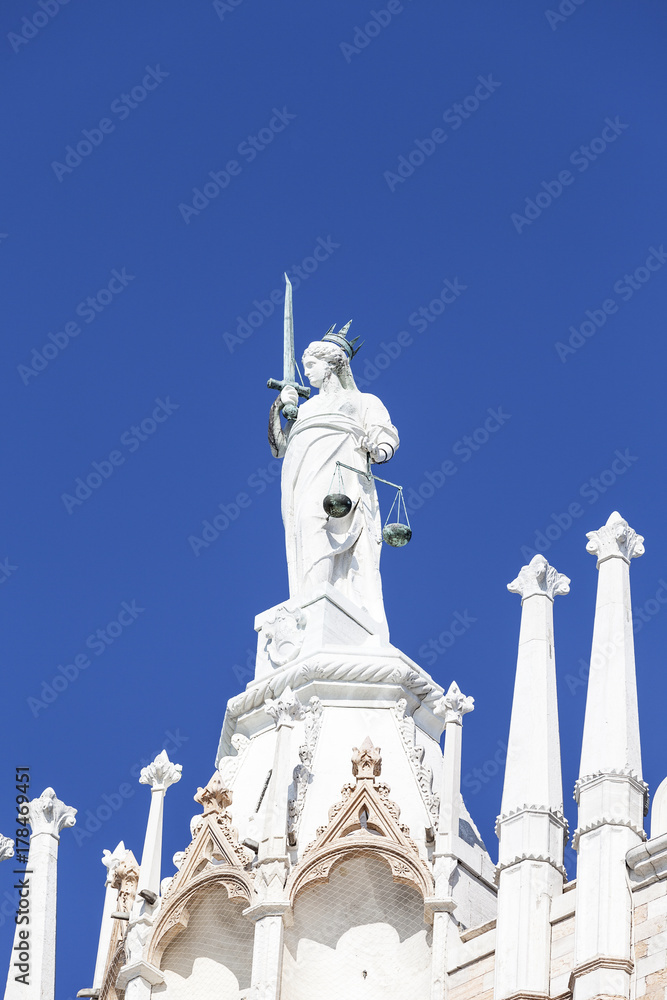 Goddess of Justice statue on the top of Doge's Palace (Palazzo Ducale) on St Mark's Square, Venice, Italy