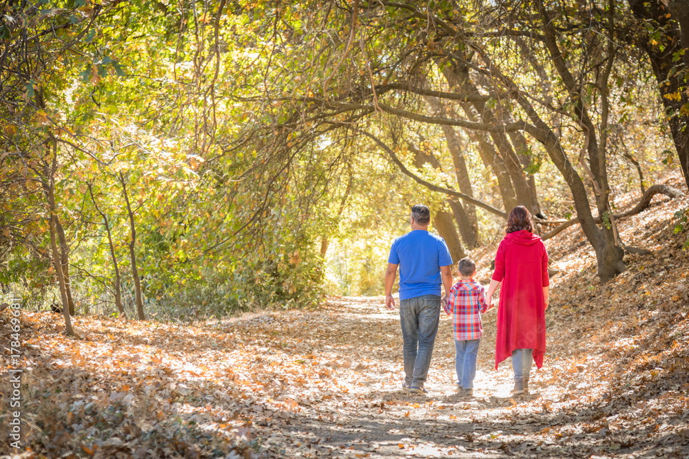 Mixed Race Caucasian and Hispanic Family Taking a Walk At The Park. Mixed Race Caucasian and Hispanic Family Taking a Walk At The Park.